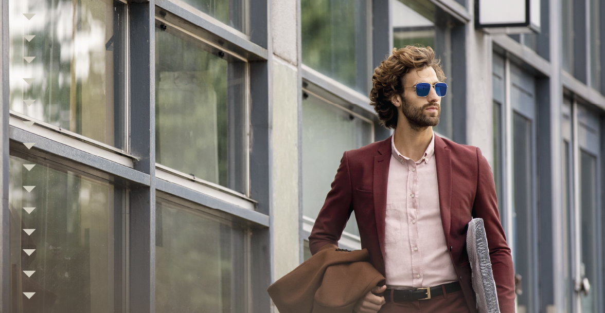 man-wearing-sunglasses-business-attire-city-sidewalk